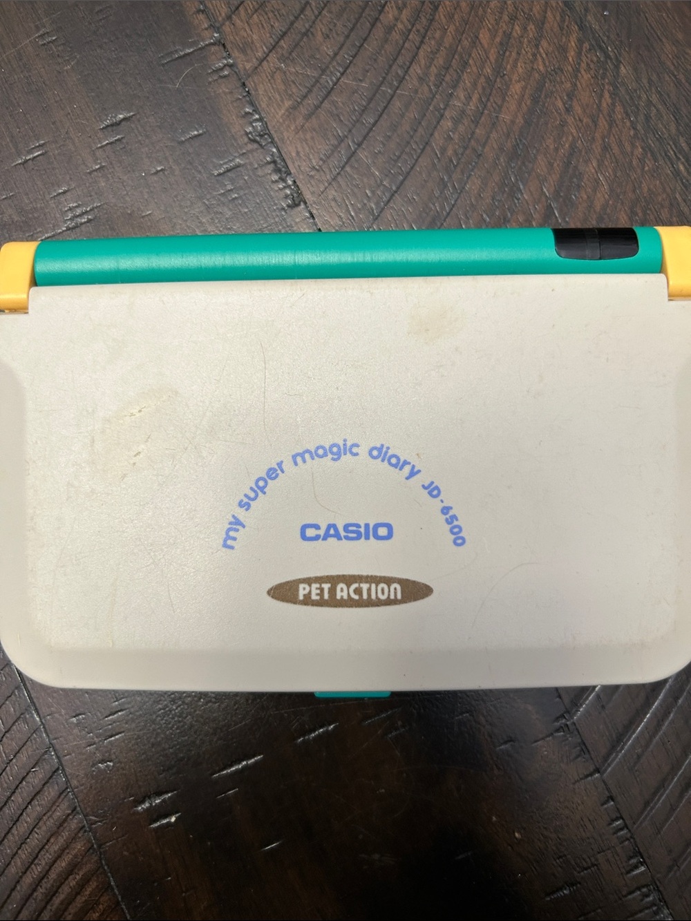 Vintage Casio Pet Action Handheld Diary in Teal, Yellow & Cream.  Not tested